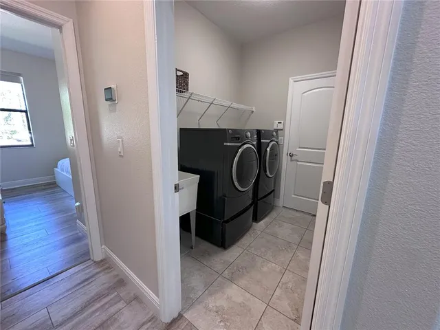 a utility room with cabinets washer and dryer