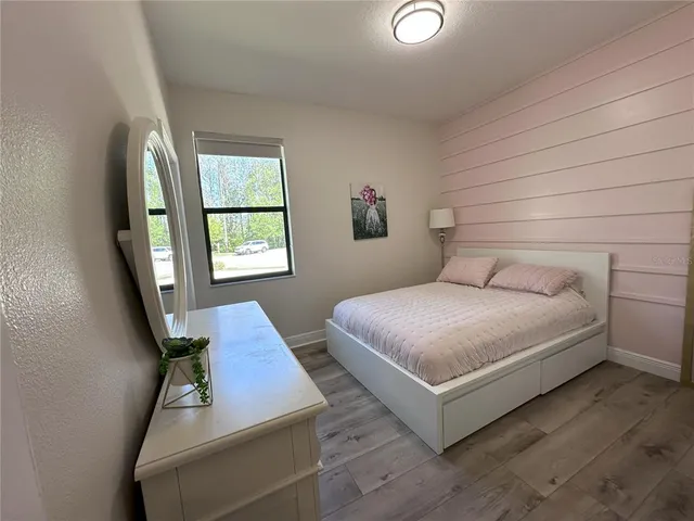 a bedroom with a bed and window