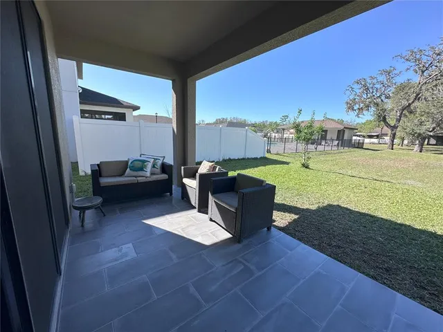 a view of a patio with dining table and chairs