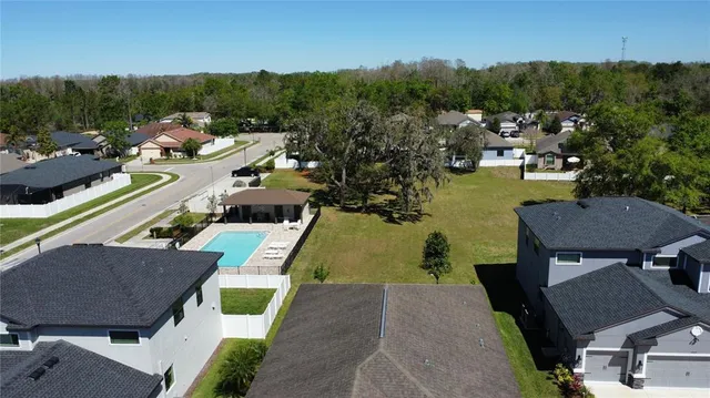 an aerial view of a house with garden space and lake view