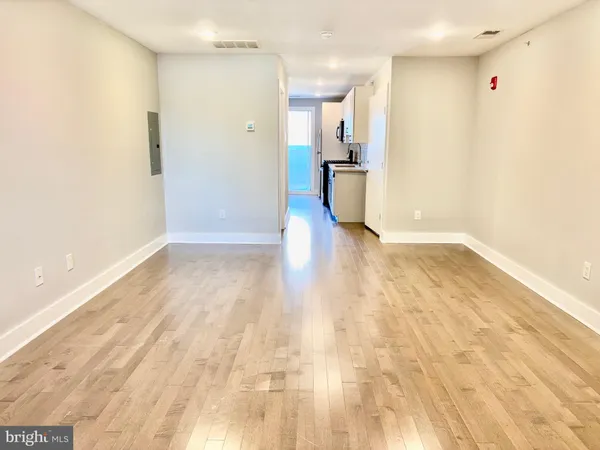 an empty room with wooden floor