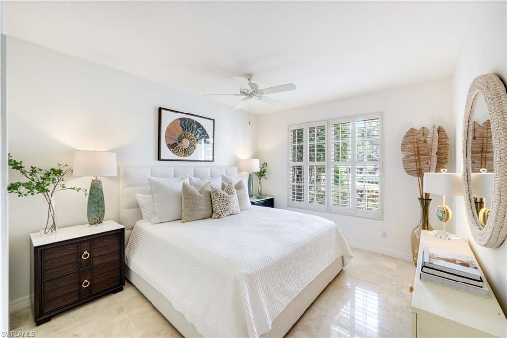 211 Via Napoli Naples, FL 34105 - Photo 25 of 50 a bedroom with a large bed and a window