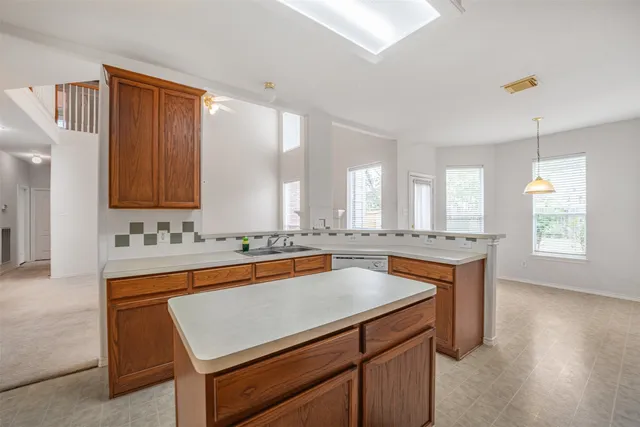 a kitchen with stainless steel appliances granite countertop a sink stove and cabinets