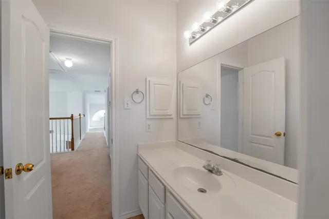 a bathroom with a sink a shower and a mirror