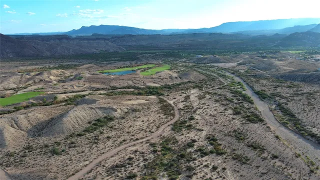 a view of a mountain with a field