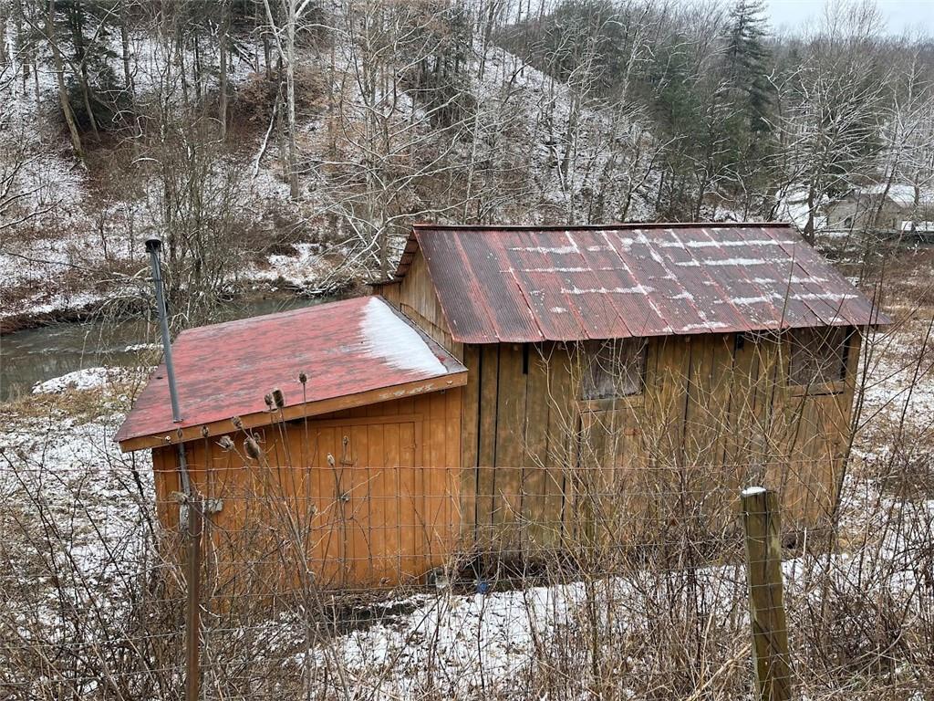 402 Deep Valley Road Aleppo, PA 15310 - Photo 6 of 7 a view of a wooden house with a small yard and large trees