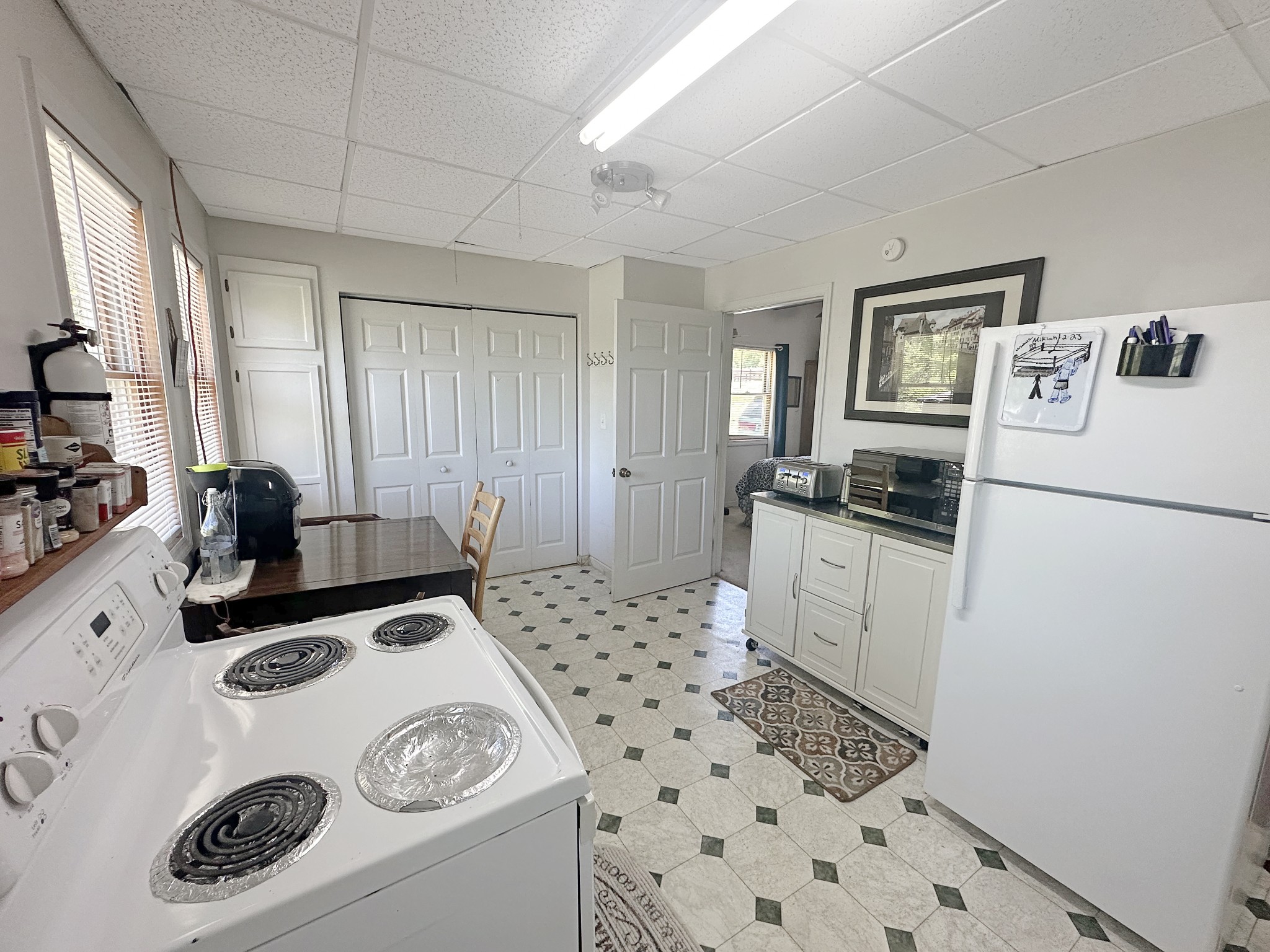 7526 South Swift Road Goodlettsville, TN 37072 - Photo 7 of 15 a kitchen with a refrigerator a stove a microwave and cabinets