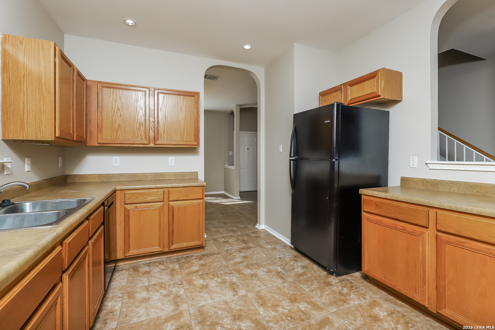 8611 Tioga Pass Helotes, TX 78023 - Photo 2 of 14 a kitchen with stainless steel appliances granite countertop a refrigerator a stove and a sink