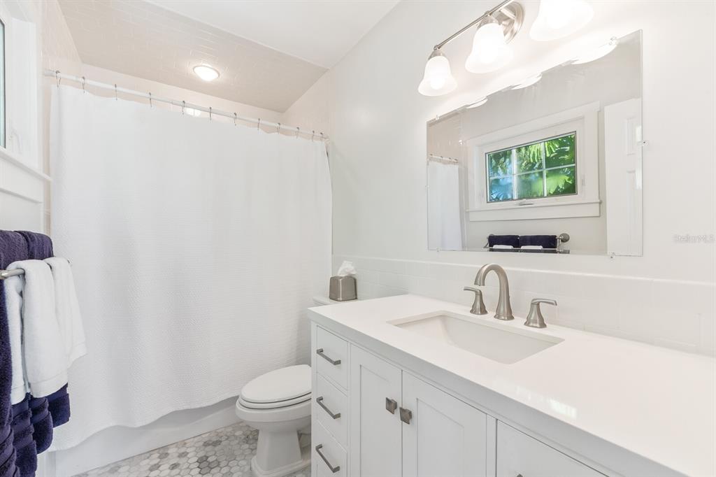 161 1st Street East Boca Grande, FL 33921 - Photo 11 of 38 a bathroom with a sink a toilet and a mirror