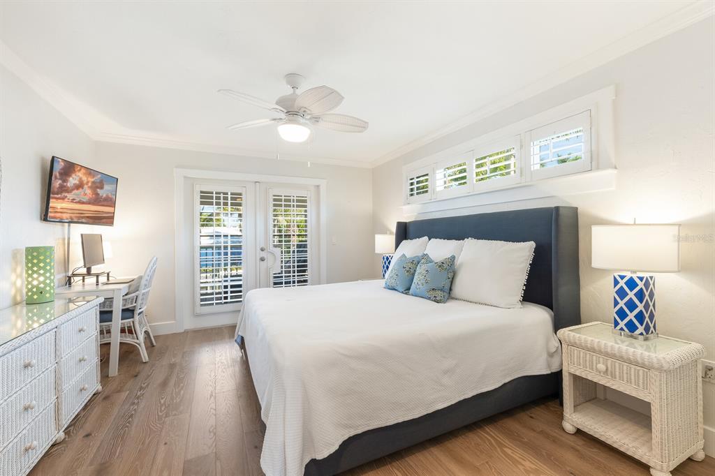 161 1st Street East Boca Grande, FL 33921 - Photo 12 of 38 a bedroom with a large bed and a window