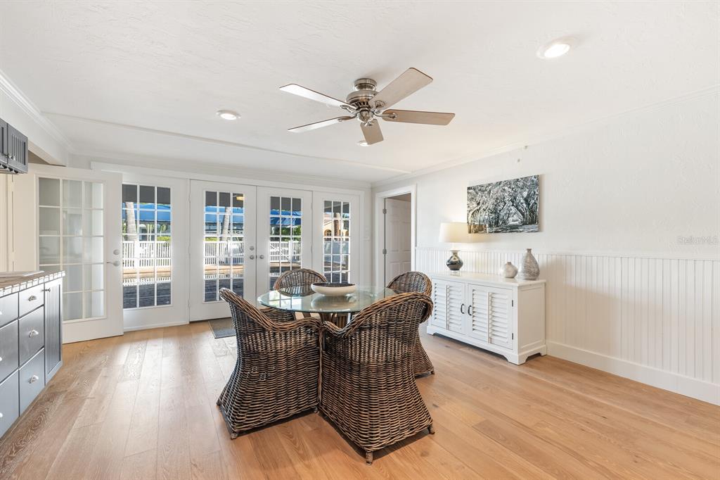 161 1st Street East Boca Grande, FL 33921 - Photo 13 of 38 a dining room with furniture a window and wooden floor