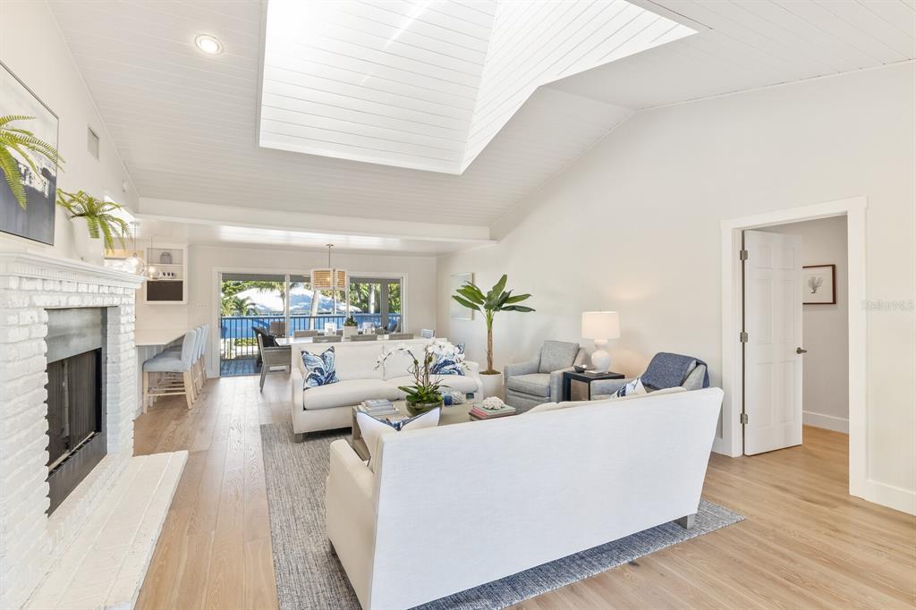 161 1st Street East Boca Grande, FL 33921 - Photo 2 of 38 a living room with furniture a fireplace and a table