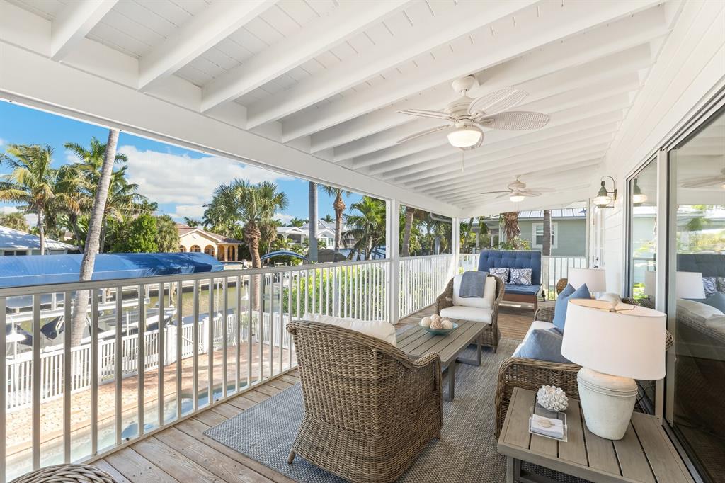 161 1st Street East Boca Grande, FL 33921 - Photo 21 of 38 a living room with furniture floor to ceiling window and wooden floor