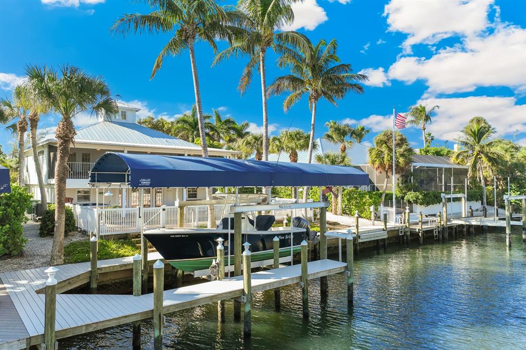 161 1st Street East Boca Grande, FL 33921 - Photo 30 of 38 a view of a lake with a table and chairs