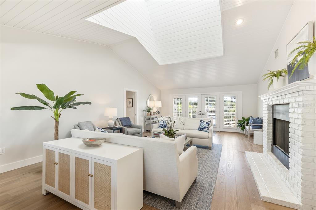 161 1st Street East Boca Grande, FL 33921 - Photo 4 of 38 a living room with furniture a fireplace and a potted plant