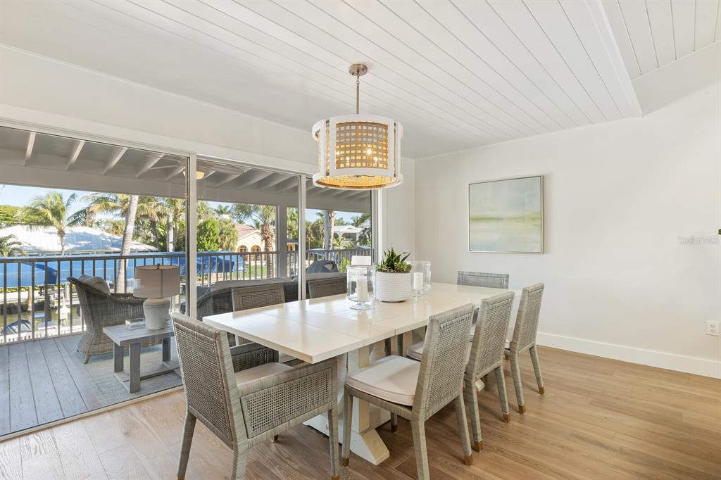 161 1st Street East Boca Grande, FL 33921 - Photo 6 of 38 a dining room with furniture a chandelier and wooden floor