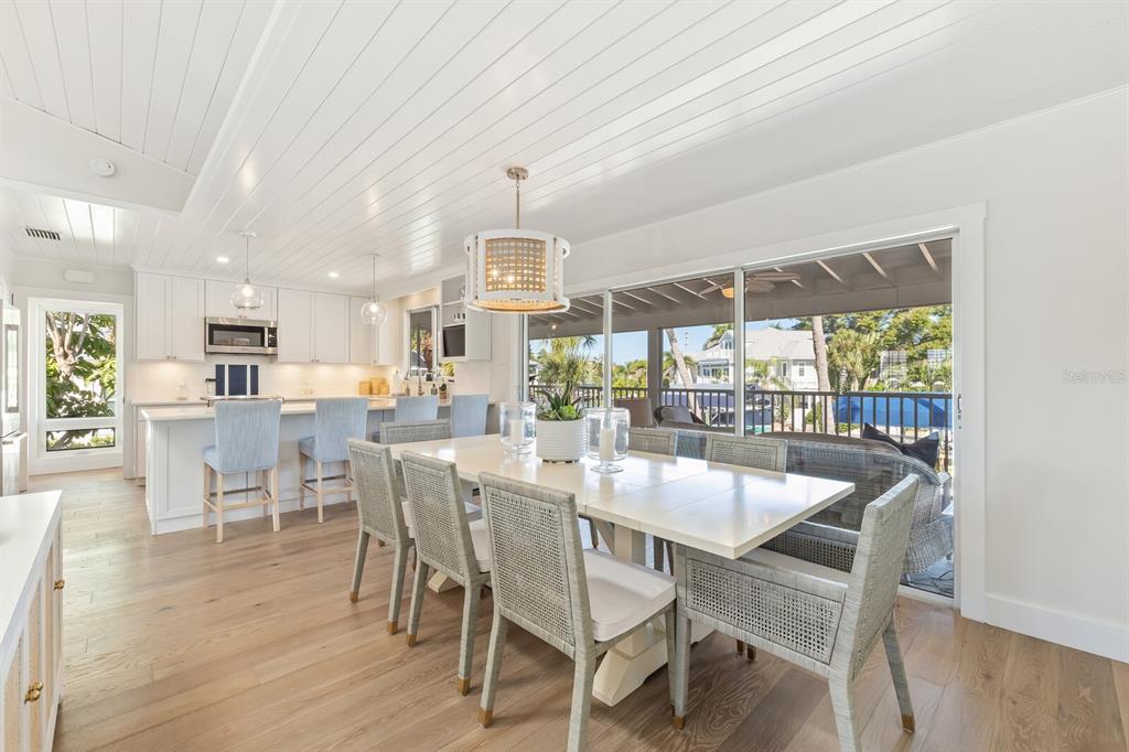 161 1st Street East Boca Grande, FL 33921 - Photo 7 of 38 a dining room with furniture a chandelier and wooden floor