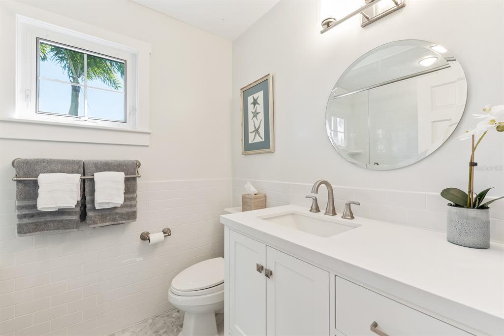 161 1st Street East Boca Grande, FL 33921 - Photo 9 of 38 a bathroom with a toilet a sink and mirror