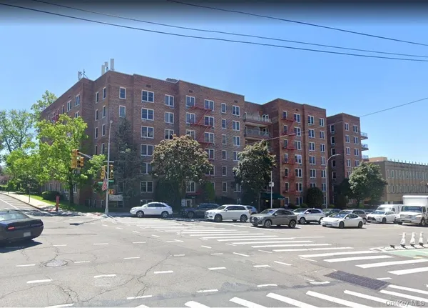 a view of a building and a cars parked in front of it