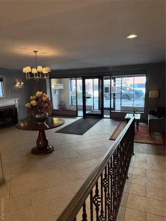 a lobby with a chandelier and rug