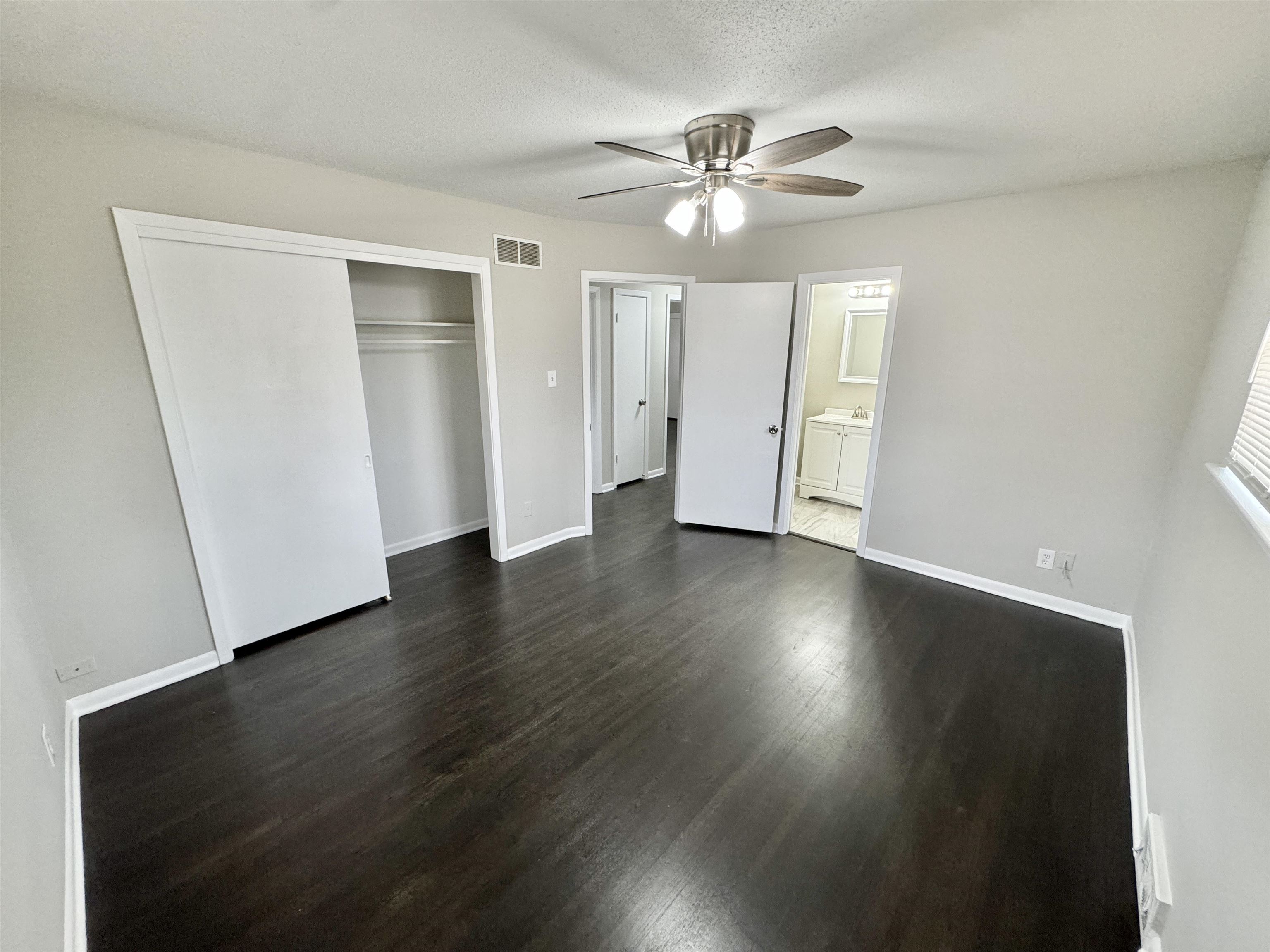 2009 West Holmes Road Memphis, TN 38109 - Photo 12 of 28 Unfurnished bedroom with baseboards, visible vents, and dark wood-style flooring
