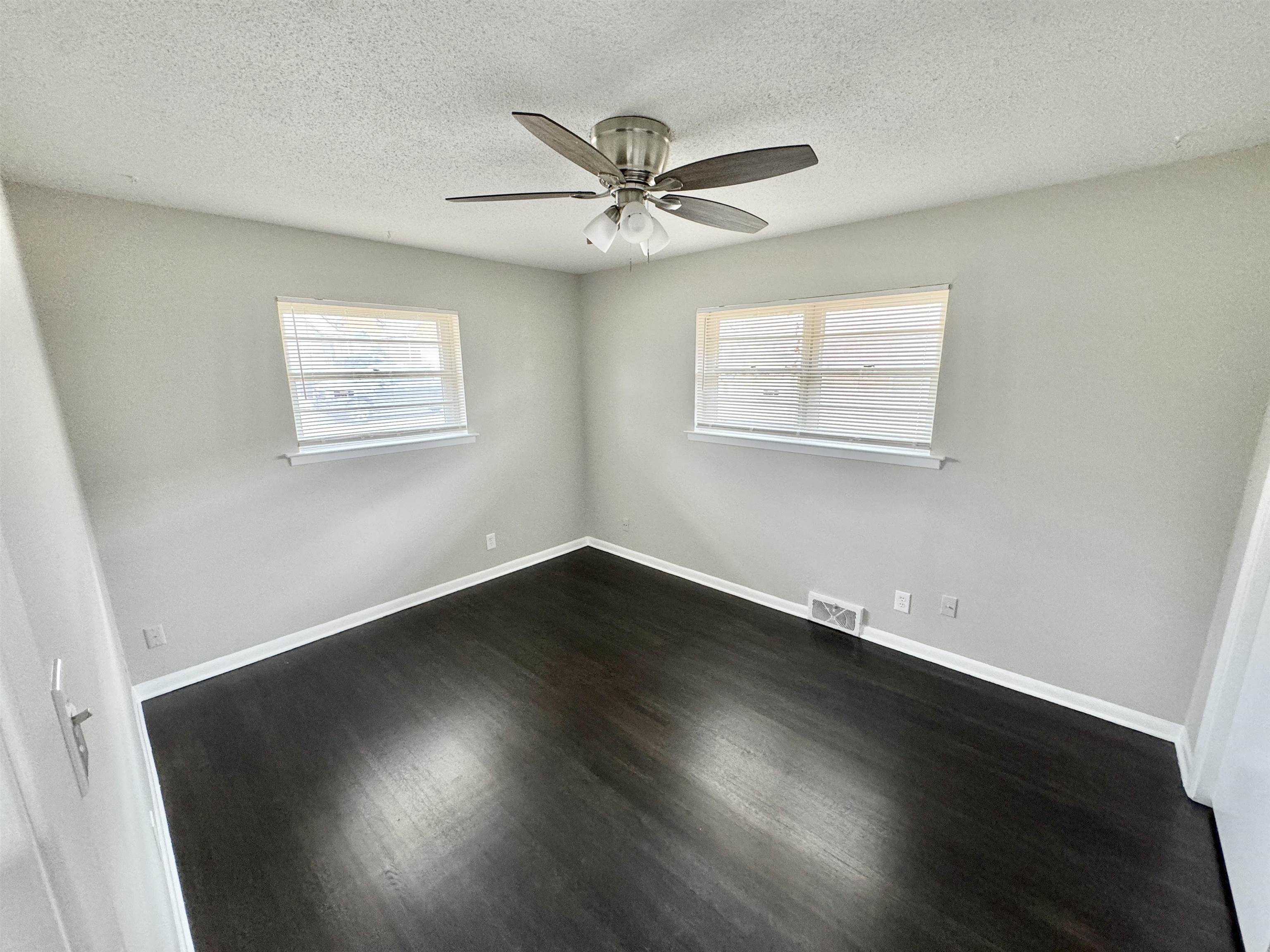 2009 West Holmes Road Memphis, TN 38109 - Photo 17 of 28 Bedroom featuring dark wood-style flooring, visible vents, ceiling fan, a textured ceiling, and baseboards