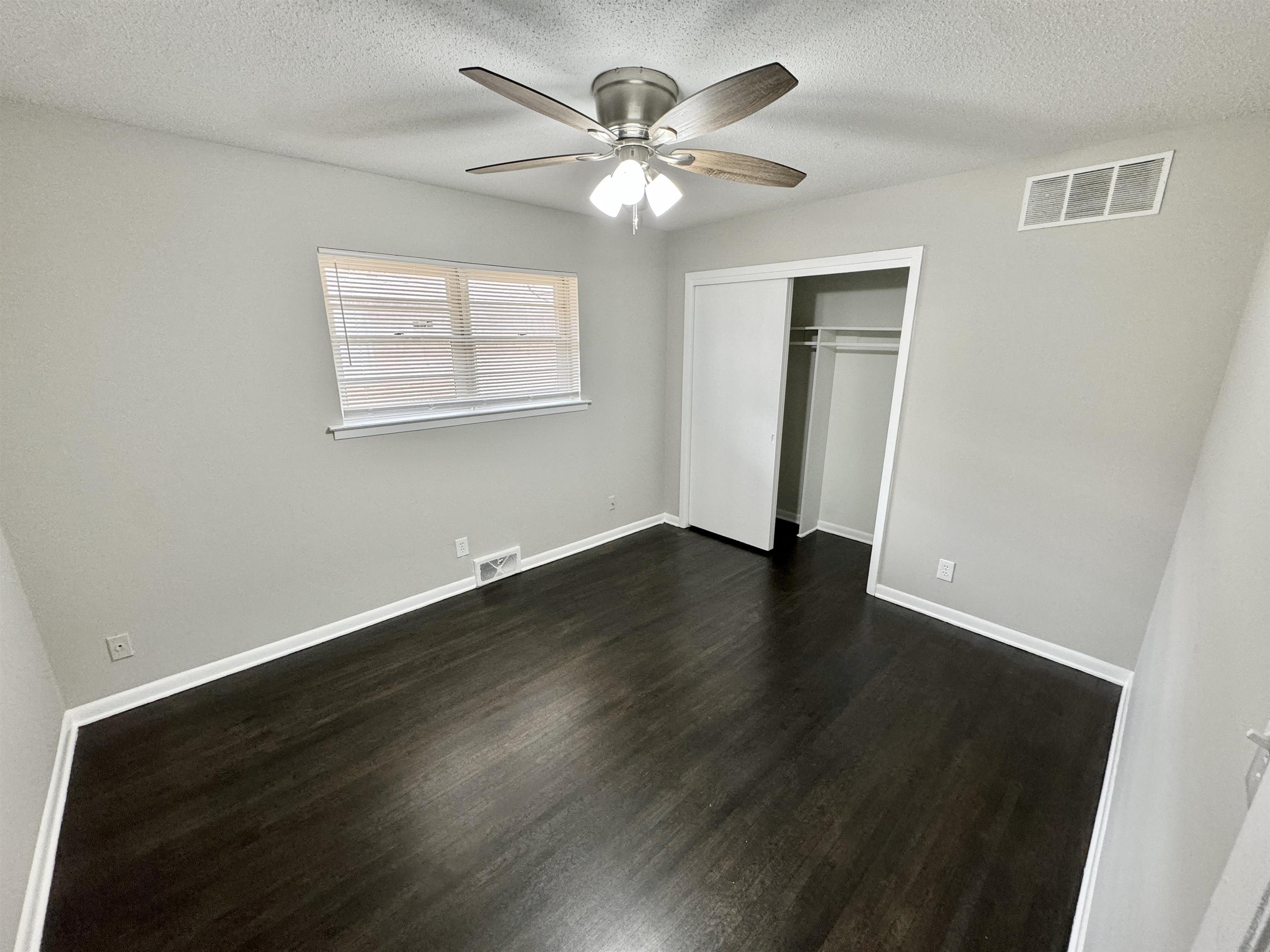 2009 West Holmes Road Memphis, TN 38109 - Photo 18 of 28 Unfurnished bedroom with dark wood finished floors, visible vents, and baseboards