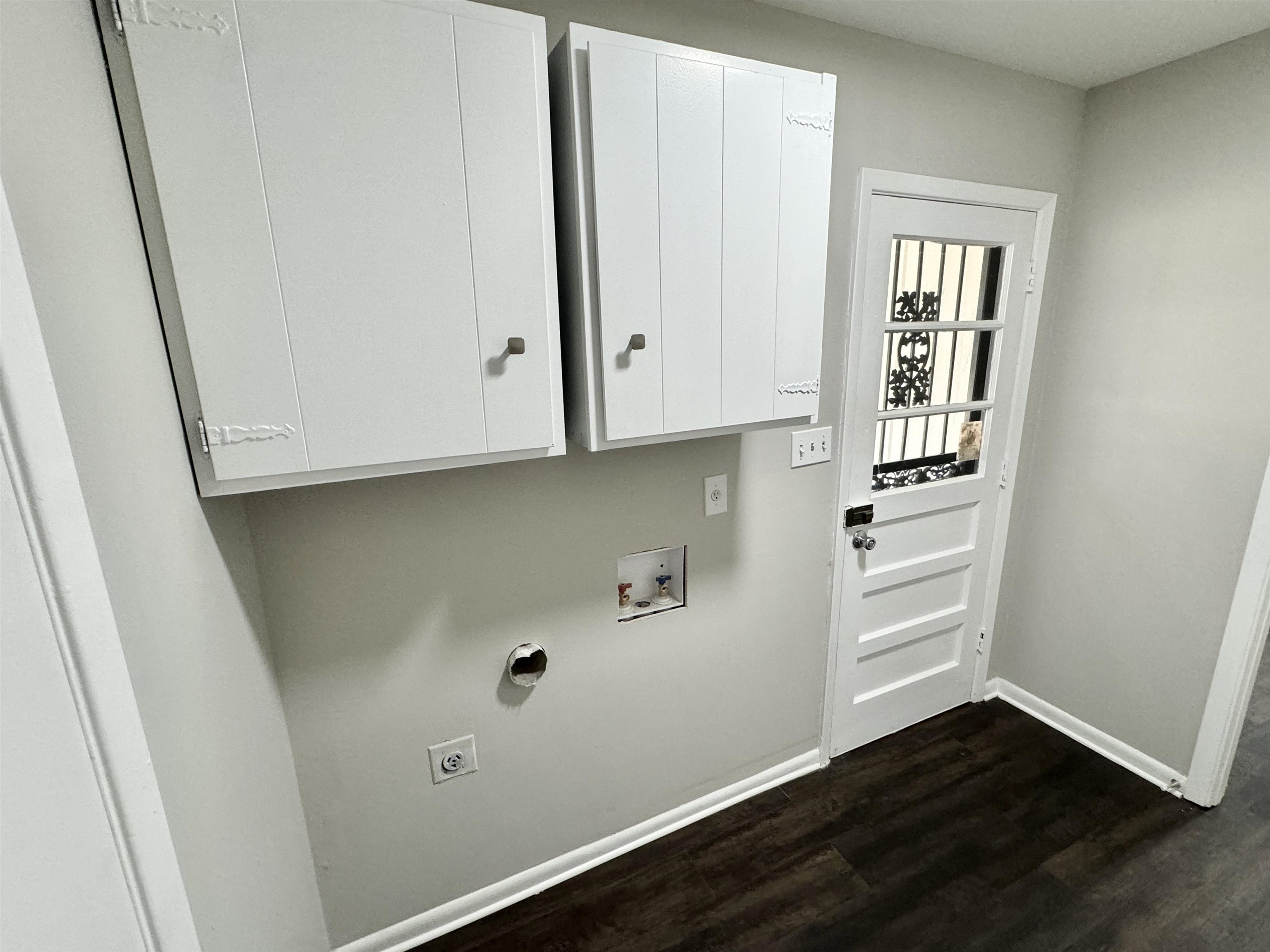 2009 West Holmes Road Memphis, TN 38109 - Photo 20 of 28 Washroom with cabinet space, baseboards, dark wood finished floors, hookup for a washing machine, and electric dryer hookup