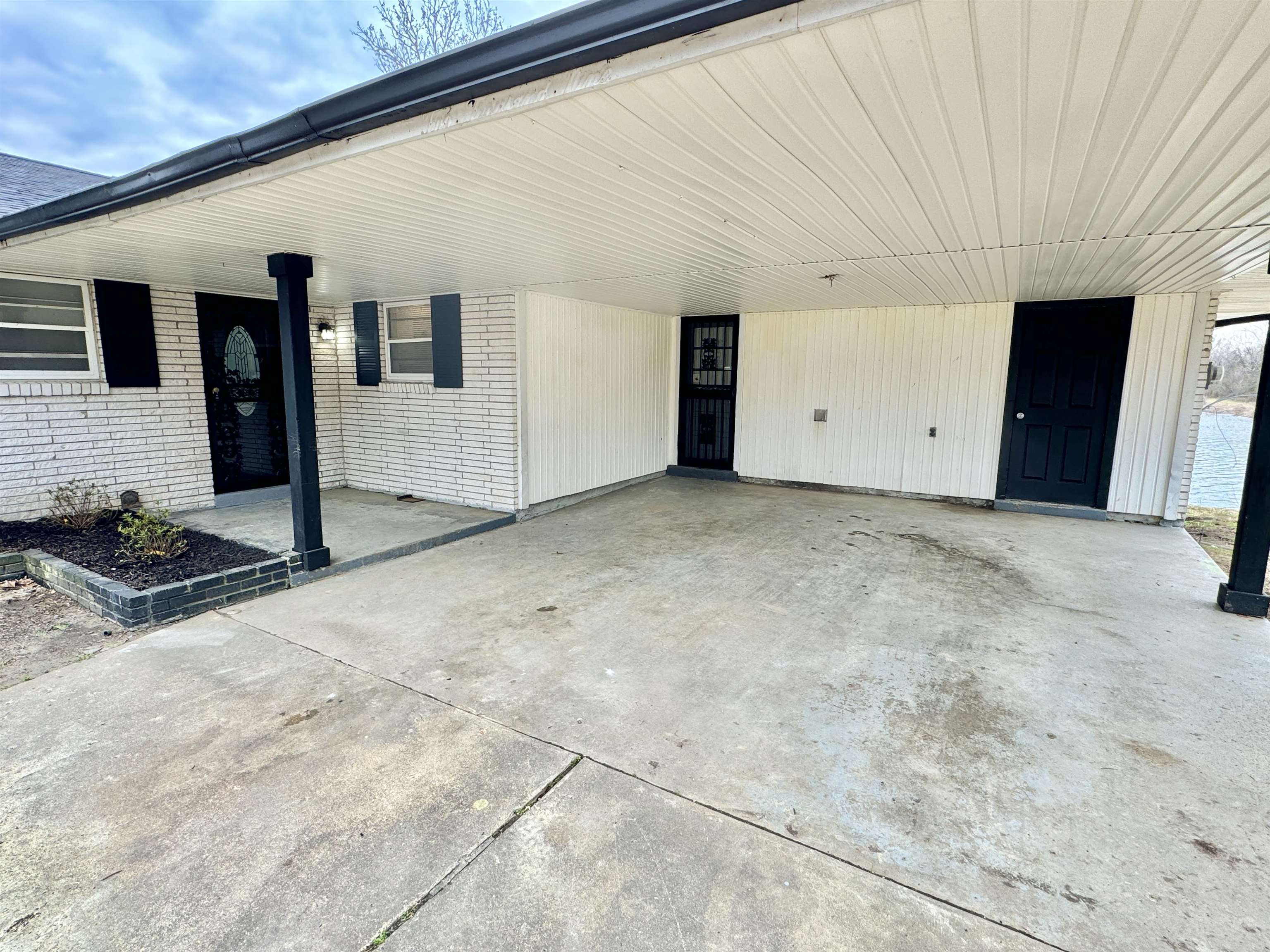 Exterior space featuring an attached carport and brick siding