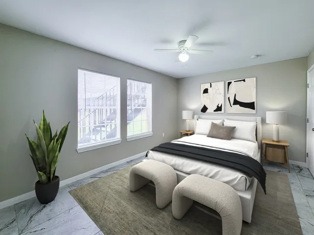 a bedroom with a large bed and a chandelier