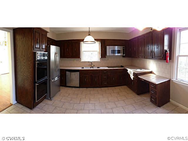 14120 Nash Road Chesterfield, VA 23838 - Photo 3 of 21 a kitchen with stainless steel appliances kitchen island granite countertop a refrigerator and a stove top oven