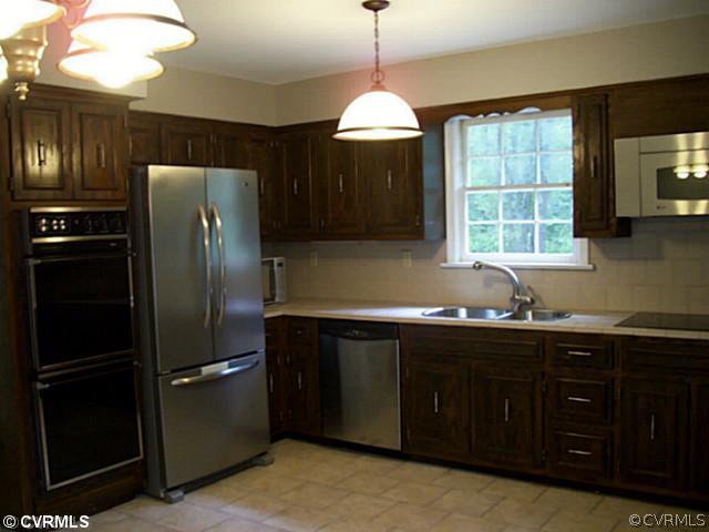14120 Nash Road Chesterfield, VA 23838 - Photo 4 of 21 a kitchen with stainless steel appliances granite countertop a refrigerator and a sink