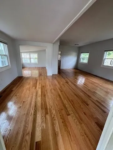 wooden floor in an empty room with a window
