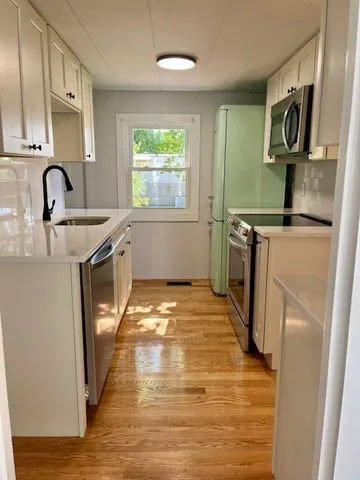 a view of room with wooden floor
