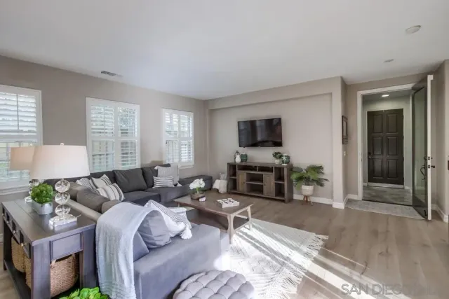 a kitchen with sink a microwave and cabinets