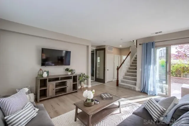 a kitchen with stainless steel appliances granite countertop a sink refrigerator and cabinets