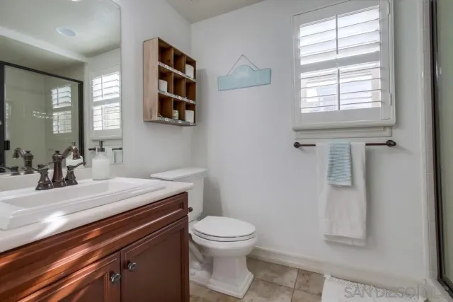 a view of a hallway with a window and wooden floor