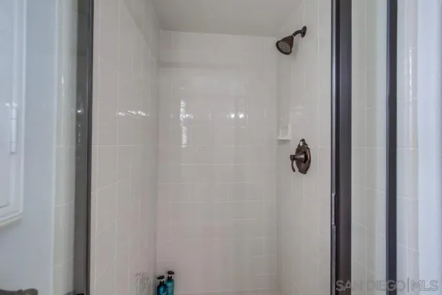 a bed room with a bed and a ceiling fan