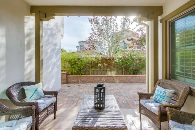 a bedroom with furniture a flat screen tv and a chandelier