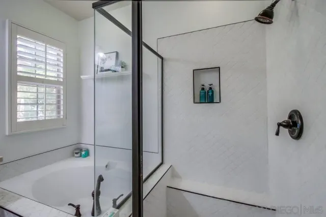a en suite bathroom with a double vanity sink a mirror and a shower