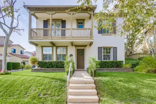 a front view of a house with a yard and porch