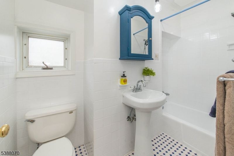 102 James Street Bloomfield, NJ 07003 - Photo 11 of 14 a bathroom with a toilet sink and mirror