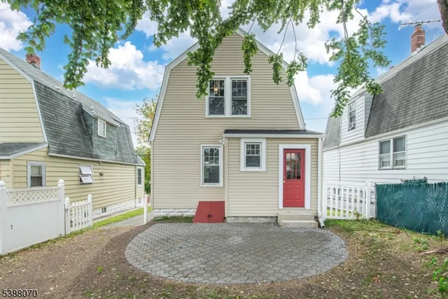 a view of a house with a backyard