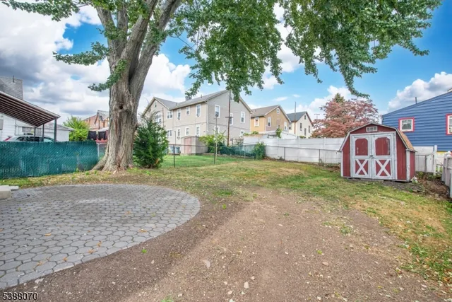 a view of a yard with a large tree