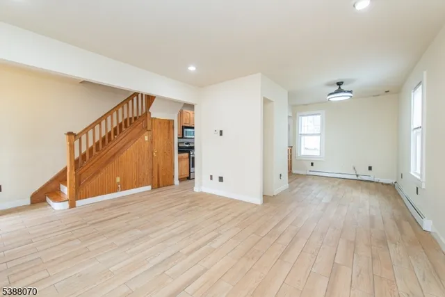a view of an empty room with wooden floor