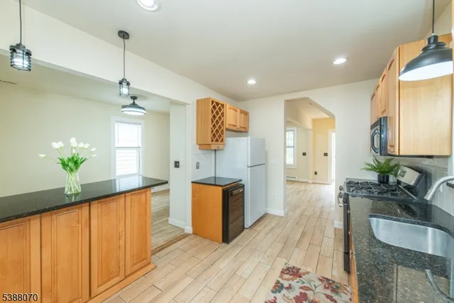 a spacious bathroom with a granite countertop sink a mirror and a bathtub