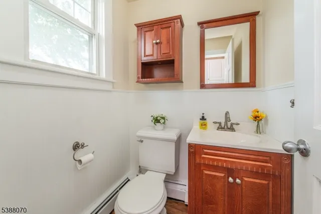 a bathroom with a toilet sink and mirror