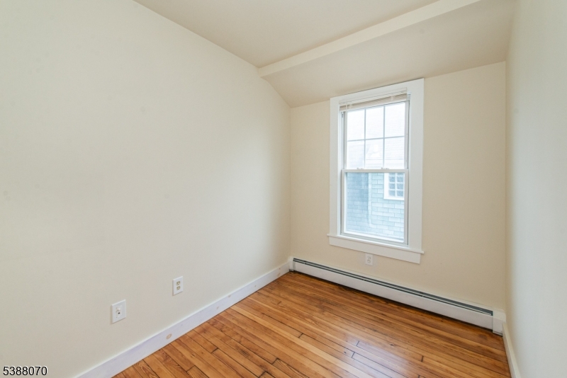 102 James Street Bloomfield, NJ 07003 - Photo 9 of 14 an empty room with wooden floor and windows