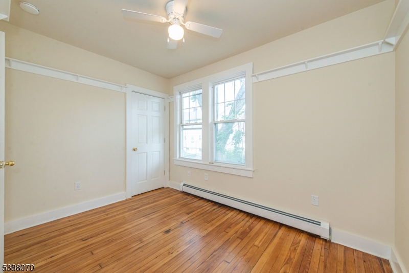 102 James Street Bloomfield, NJ 07003 - Photo 10 of 14 wooden floor in an empty room with a window