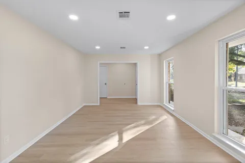 an empty room with windows and entrance